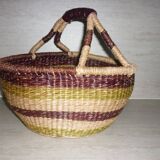 Round and colorful straw basket with handles
