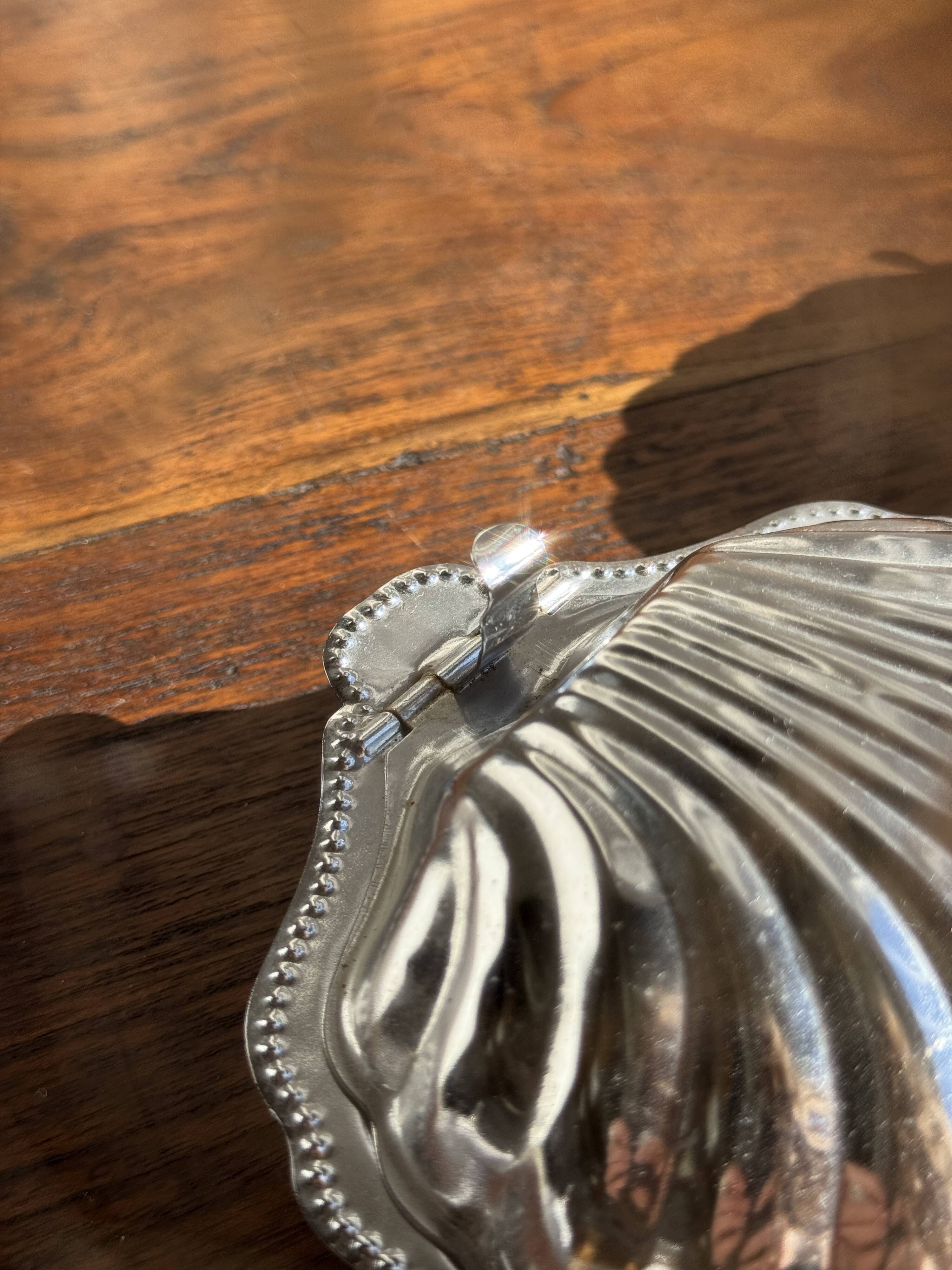 Vintage silver-plated shell butter dish with transparent bowl.