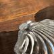 Vintage silver-plated shell butter dish with transparent bowl.
