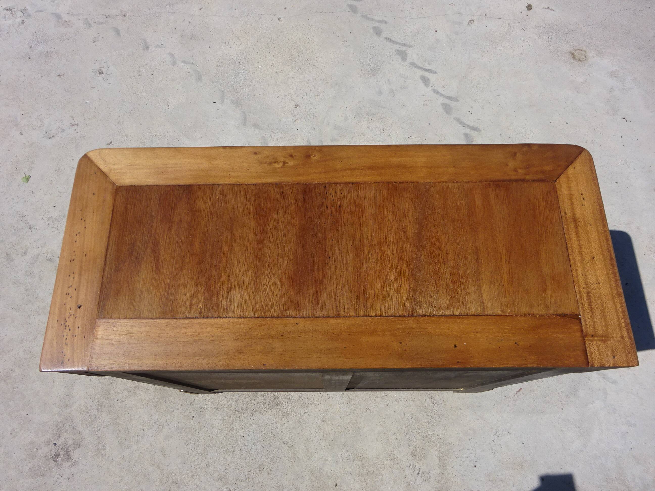 Chest of drawers with decorated handles in the Louis XVI style.