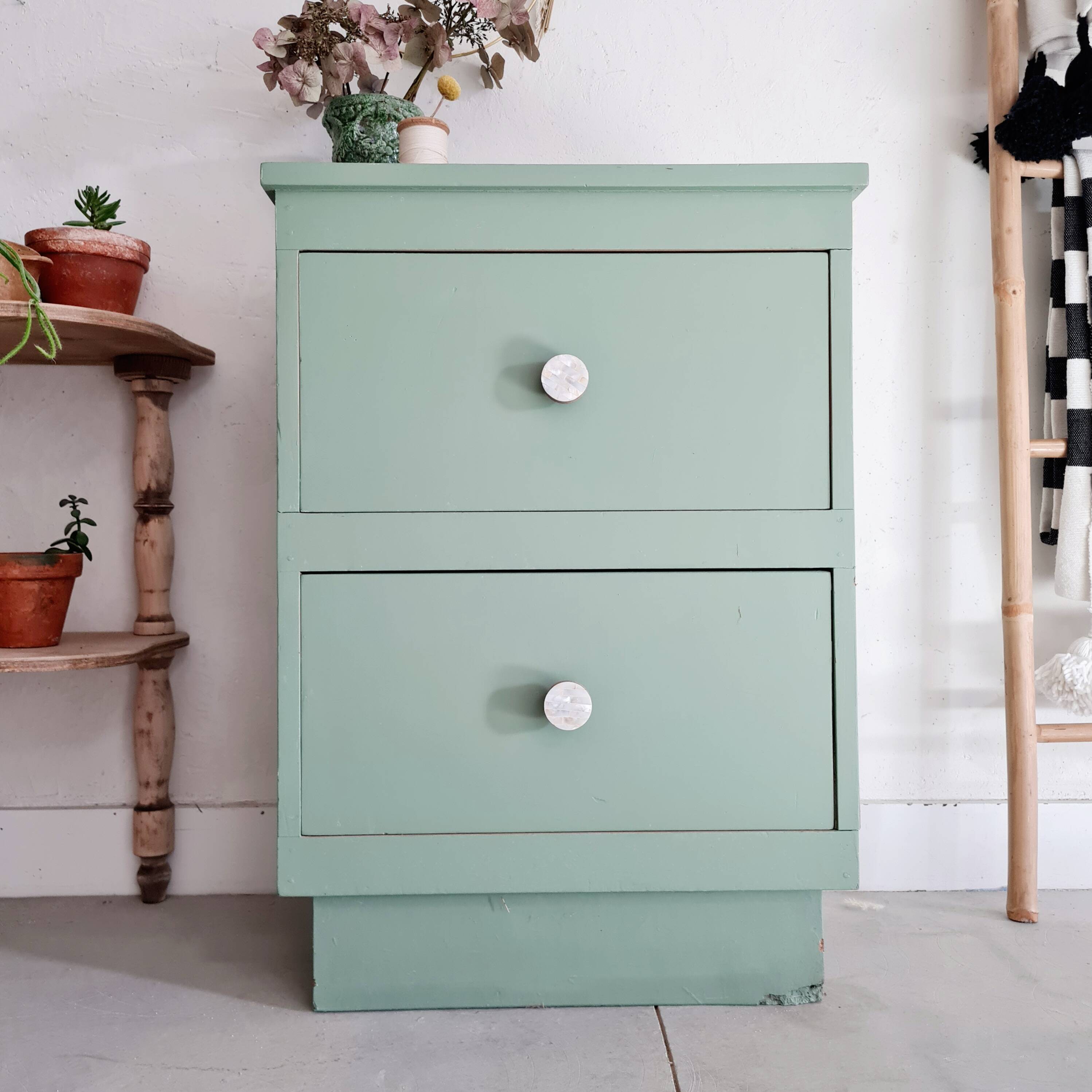 Old chest of drawers with two green drawers