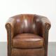 Sheepskin clubarmchair with beautiful patina finished with decorative nails