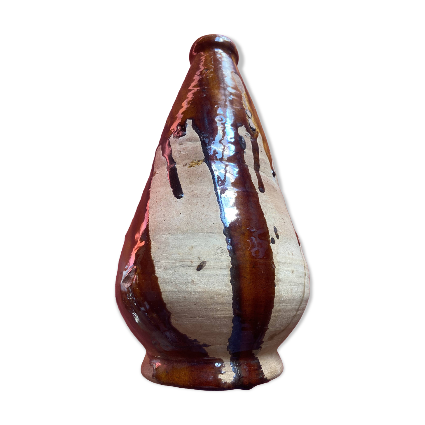 Large antique pottery bottle in glazed terracotta with drips.