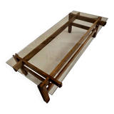 Glass coffee table with a wooden frame.