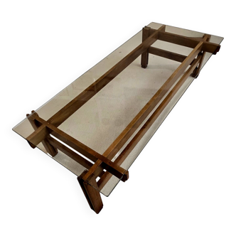 Glass coffee table with a wooden frame.
