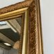 Gilded mirror with frieze h2m10 l:73cm