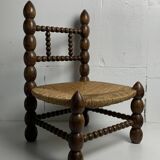 Brutalist wood turned bobbin low rush chair in the style of Charles Dudouyt