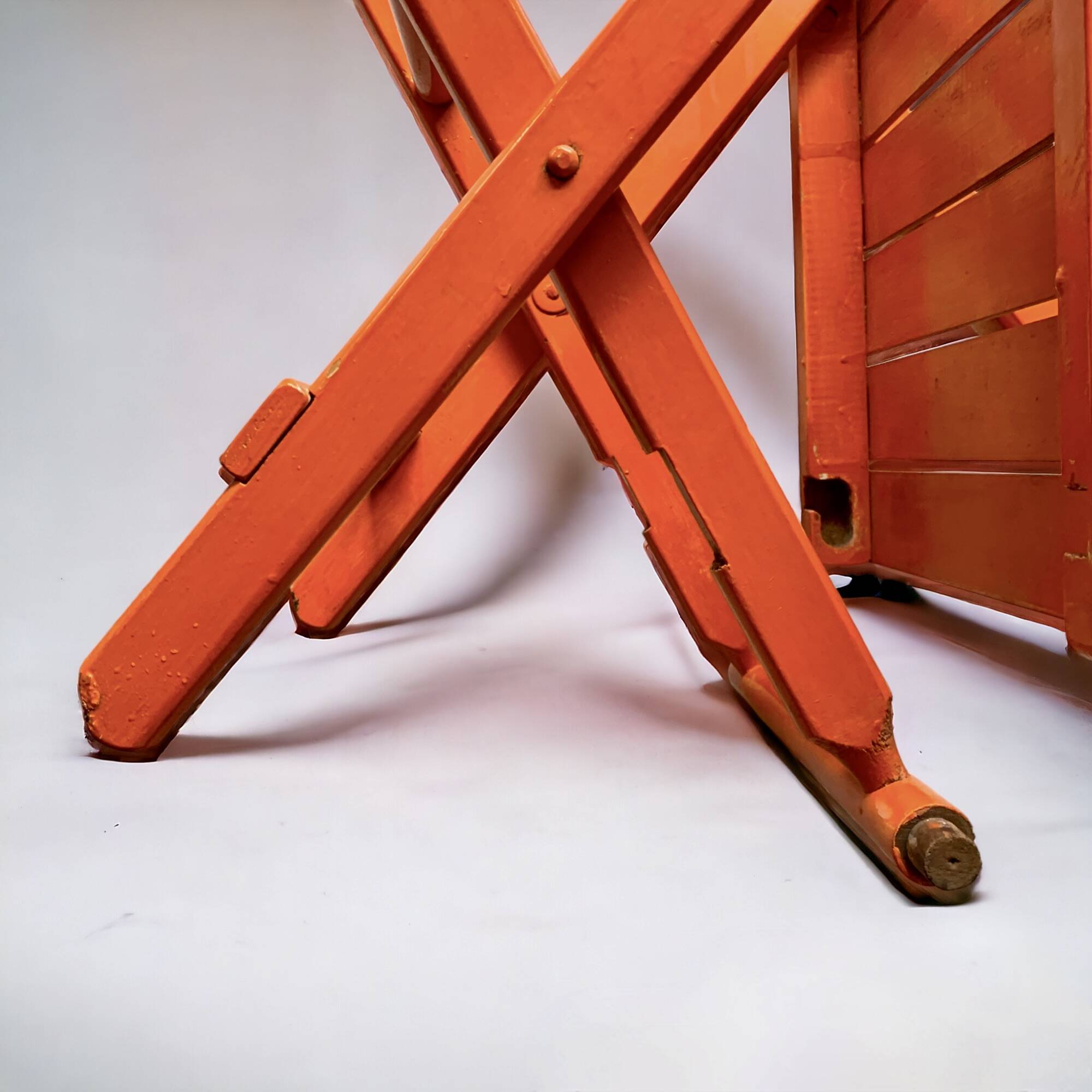 Vintage folding chair in orange painted wood