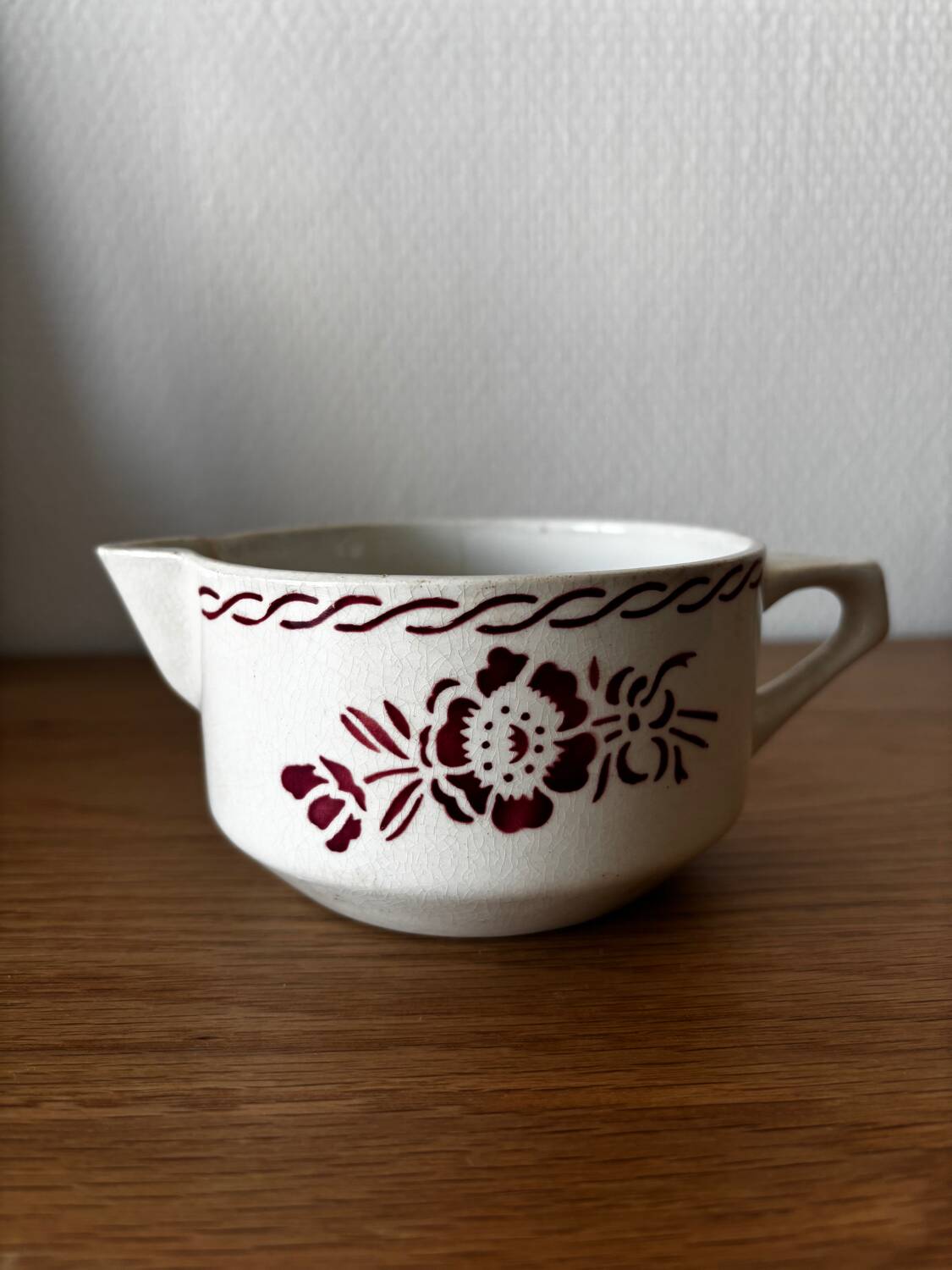 Vintage old sauceboat with pink flowers in St Amand