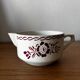 Vintage old sauceboat with pink flowers in St Amand
