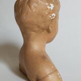 Bust of a small child in ancient plaster