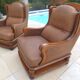 Pair of aged leather armchairs with seat and firm backrest with cherry wood frame