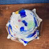 Multi-layer glass ashtray with metallic oxide inclusions.