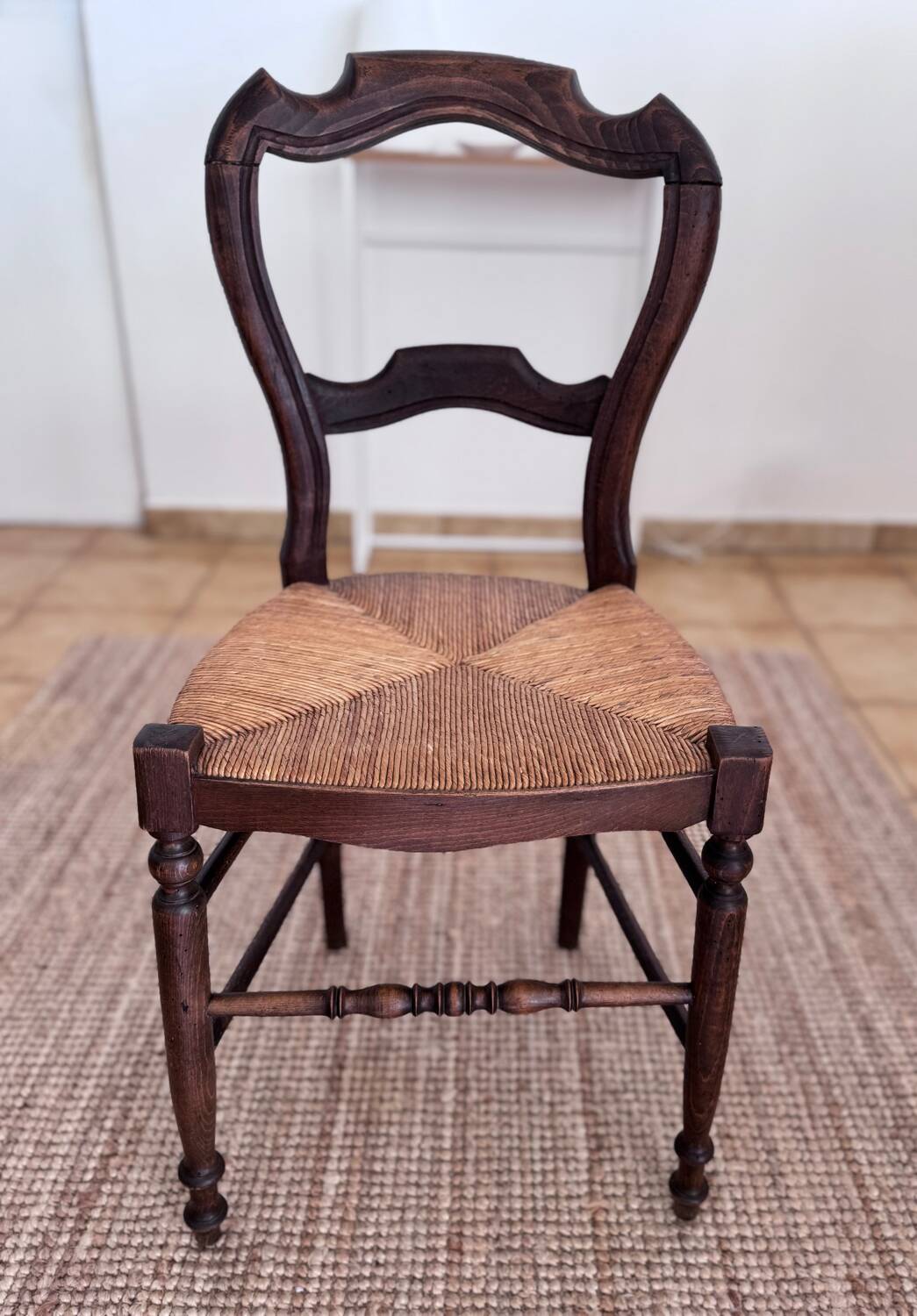 Antique wooden chairs with rush seating.
