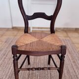 Antique wooden chairs with rush seating.