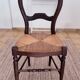 Antique wooden chairs with rush seating.