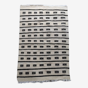 White and black hand-woven Berber rug in natural wool