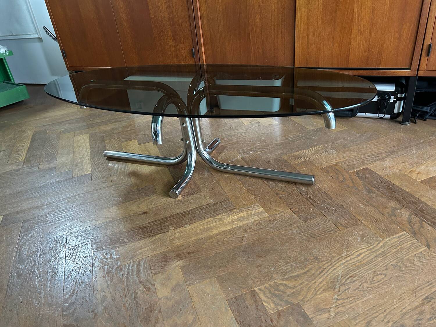 70s design oval coffee table in smoked black glass with chrome legs.