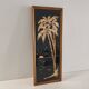 Vintage frame with palm tree and sun in wood or wicker.
