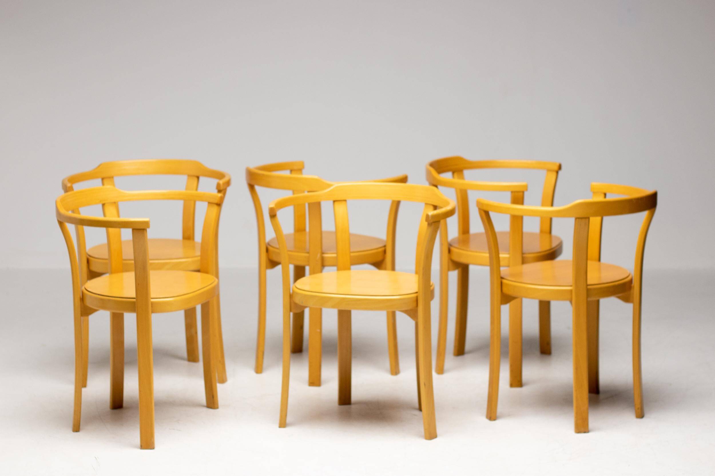 Stackable chairs in curved beech.