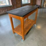 Vintage wooden high table on wheels