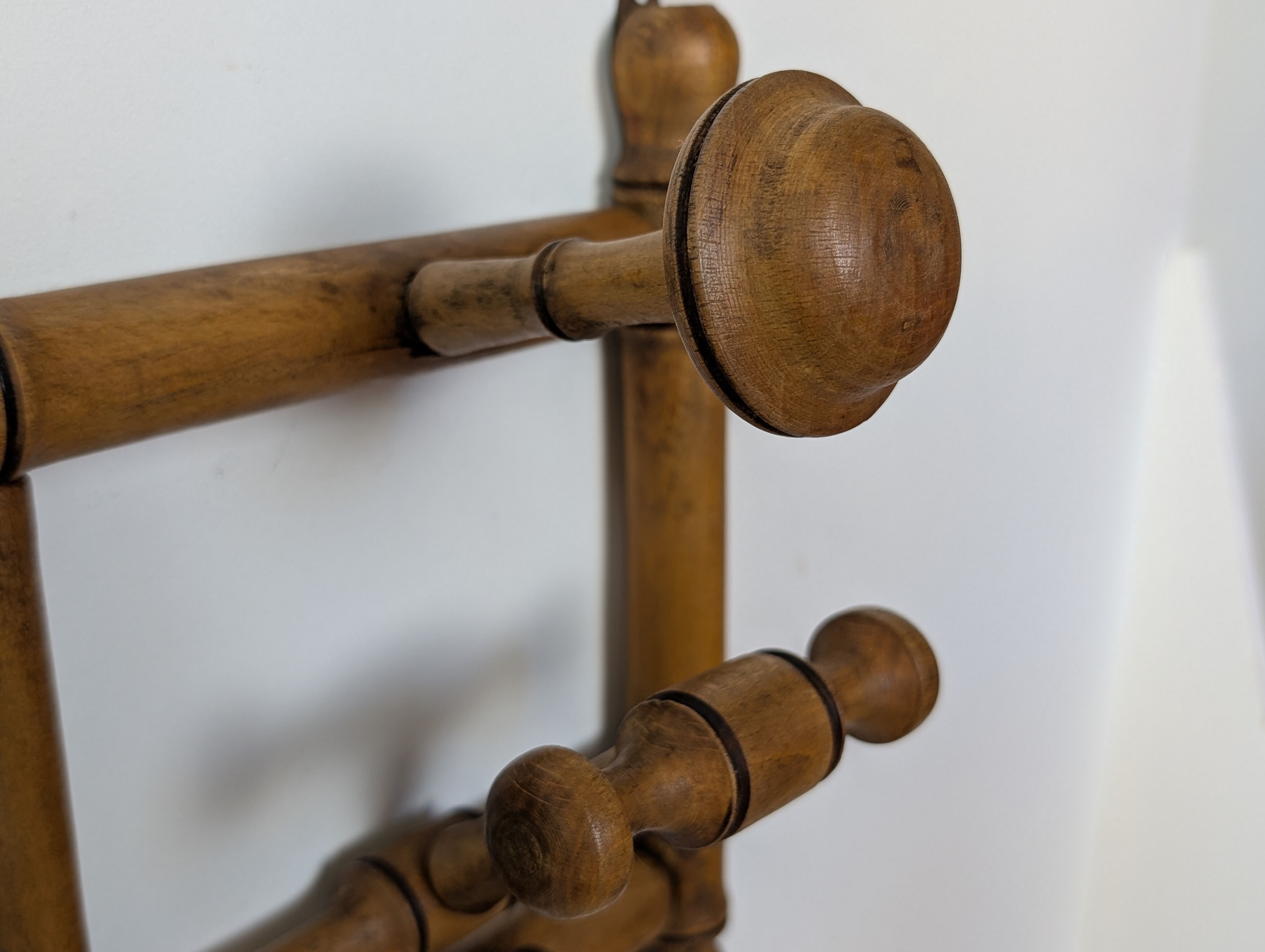 Wall-mounted coat rack made of turned wood