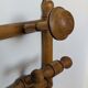 Wall-mounted coat rack made of turned wood
