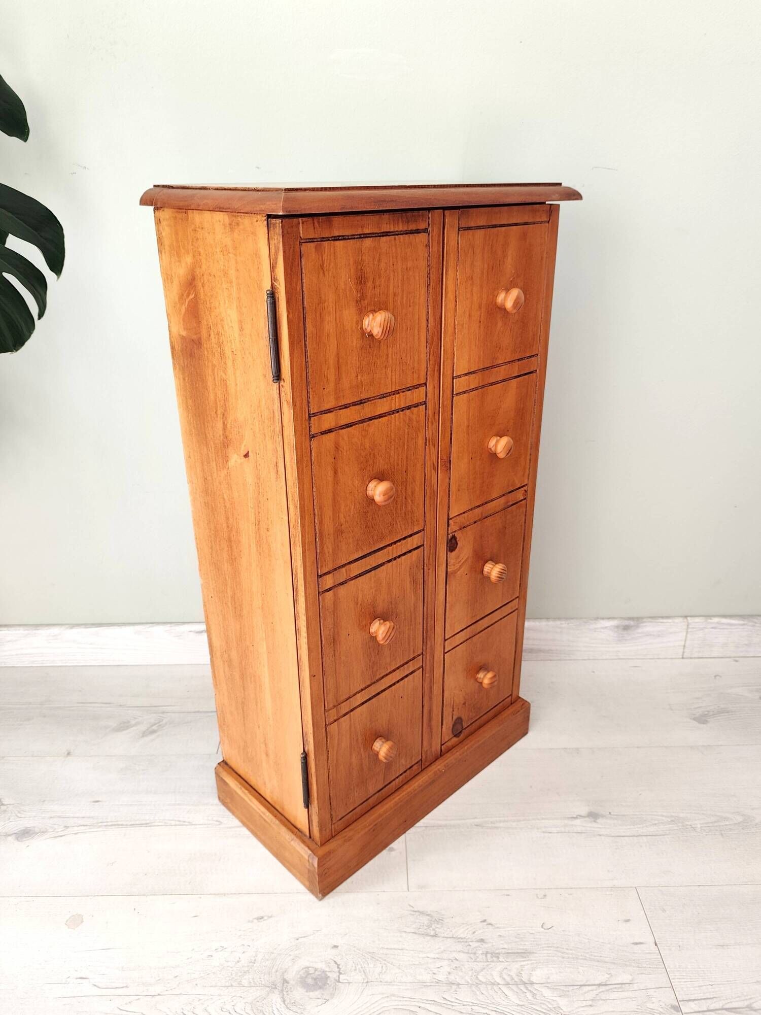 Small wooden piece of furniture, cabinet style, false drawers.