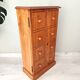 Small wooden piece of furniture, cabinet style, false drawers.