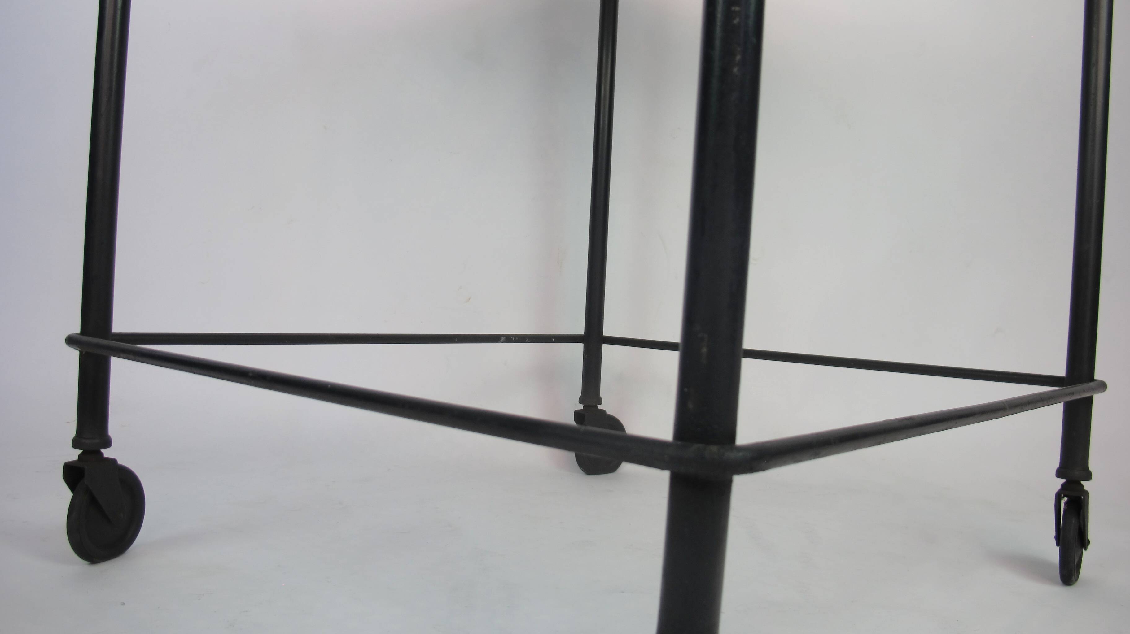 Mathieu Mategot's black wheelie table, 1950