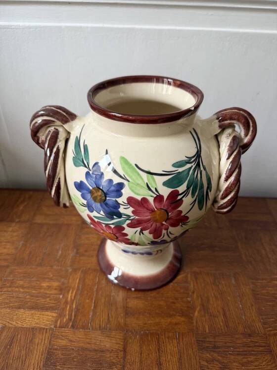 Ceramic vase with hand-painted floral decoration.