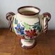 Ceramic vase with hand-painted floral decoration.