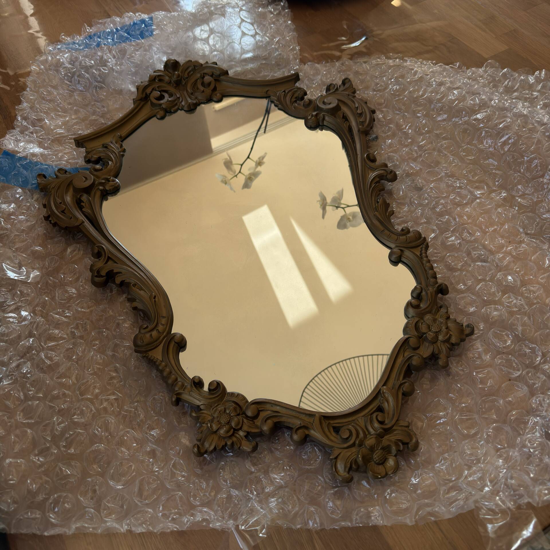 Antique mirror in Louis XV Rocaille style with carved frame.