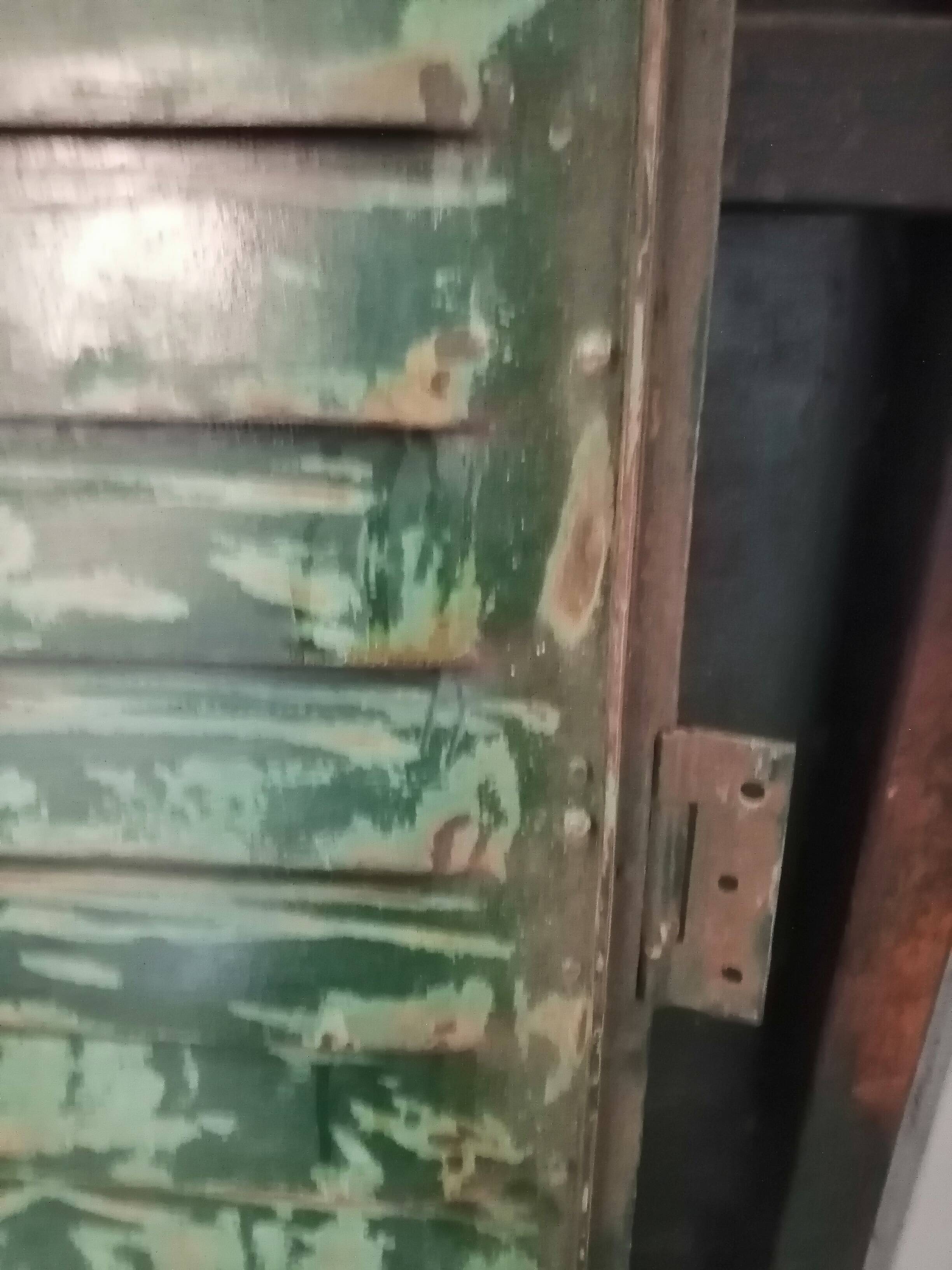 Lot of old green shutters in 4-part iron screen headboard