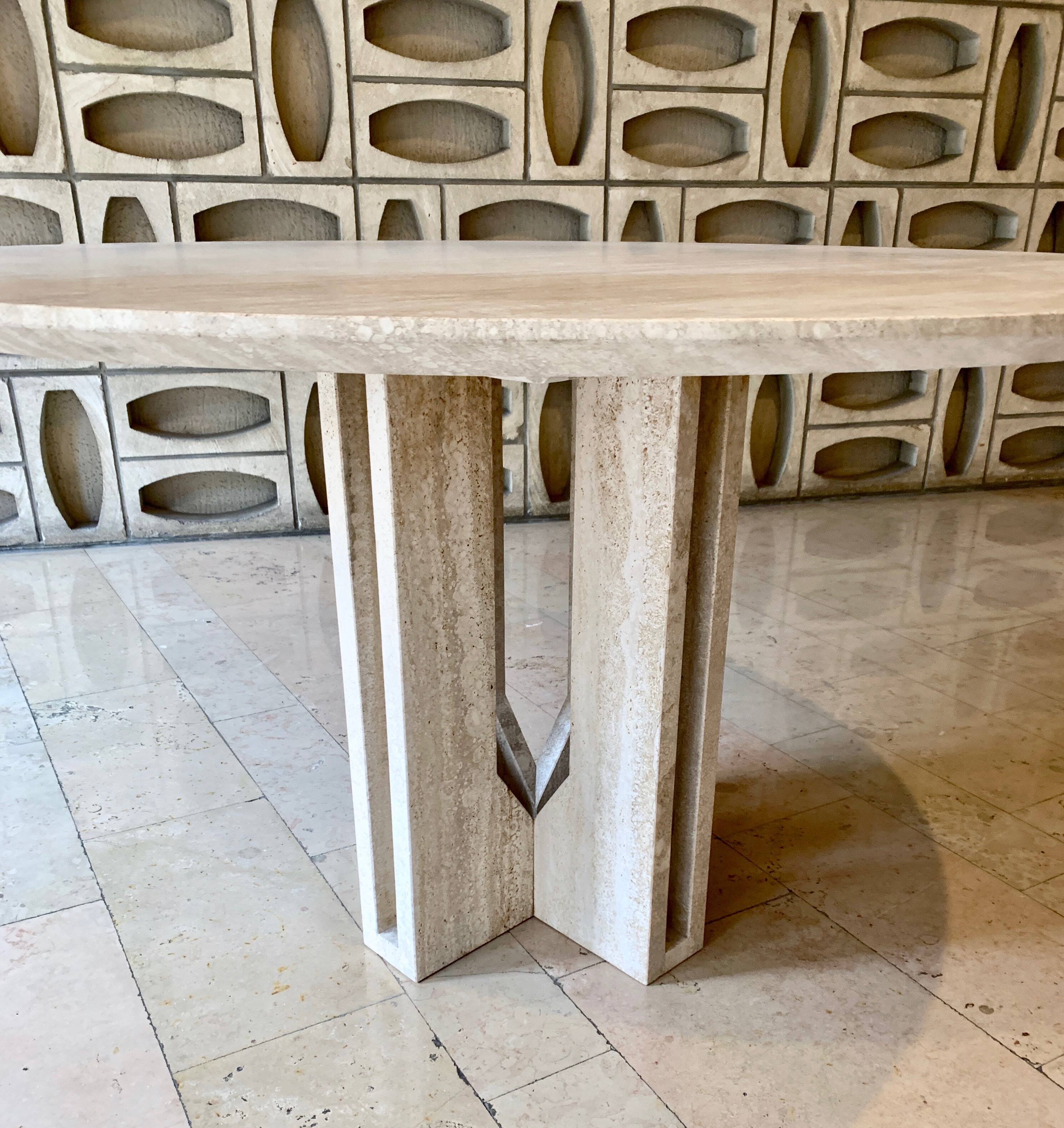 Round travertine dining table by Claude Berraldacci