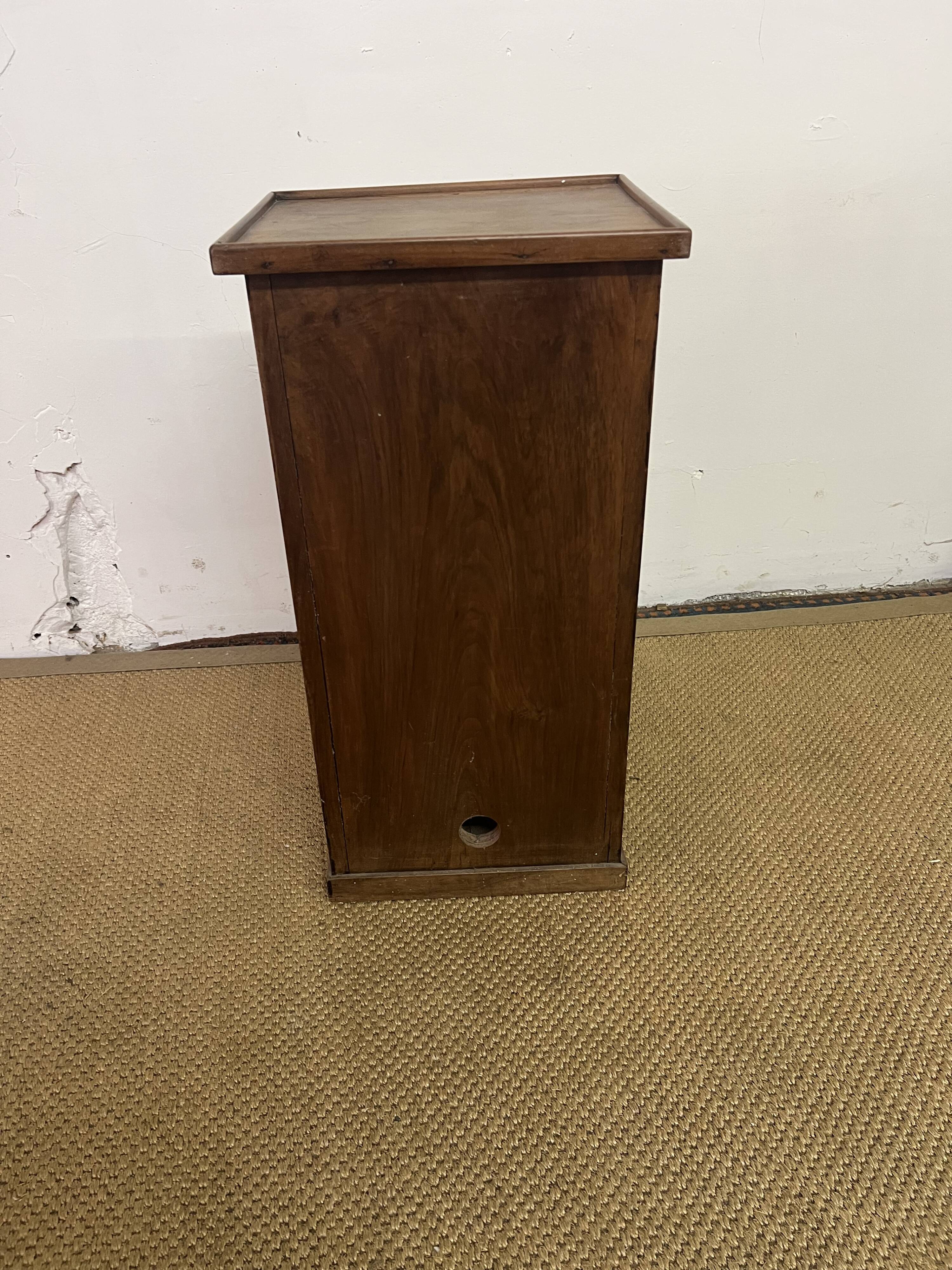 Old small storage unit with sliding and hinged doors.