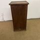 Old small storage unit with sliding and hinged doors.