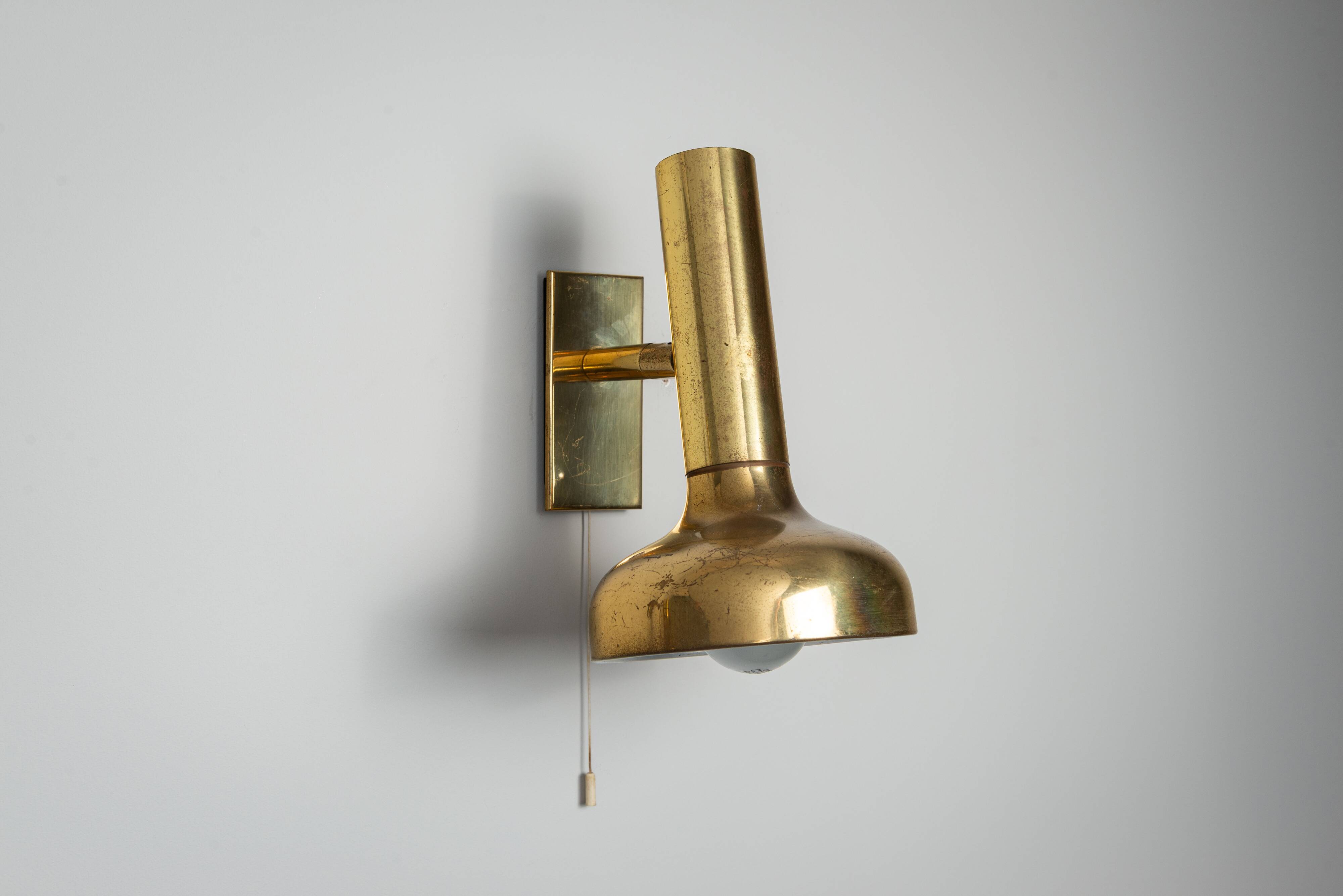 Set of three brass adjustable wall lamps