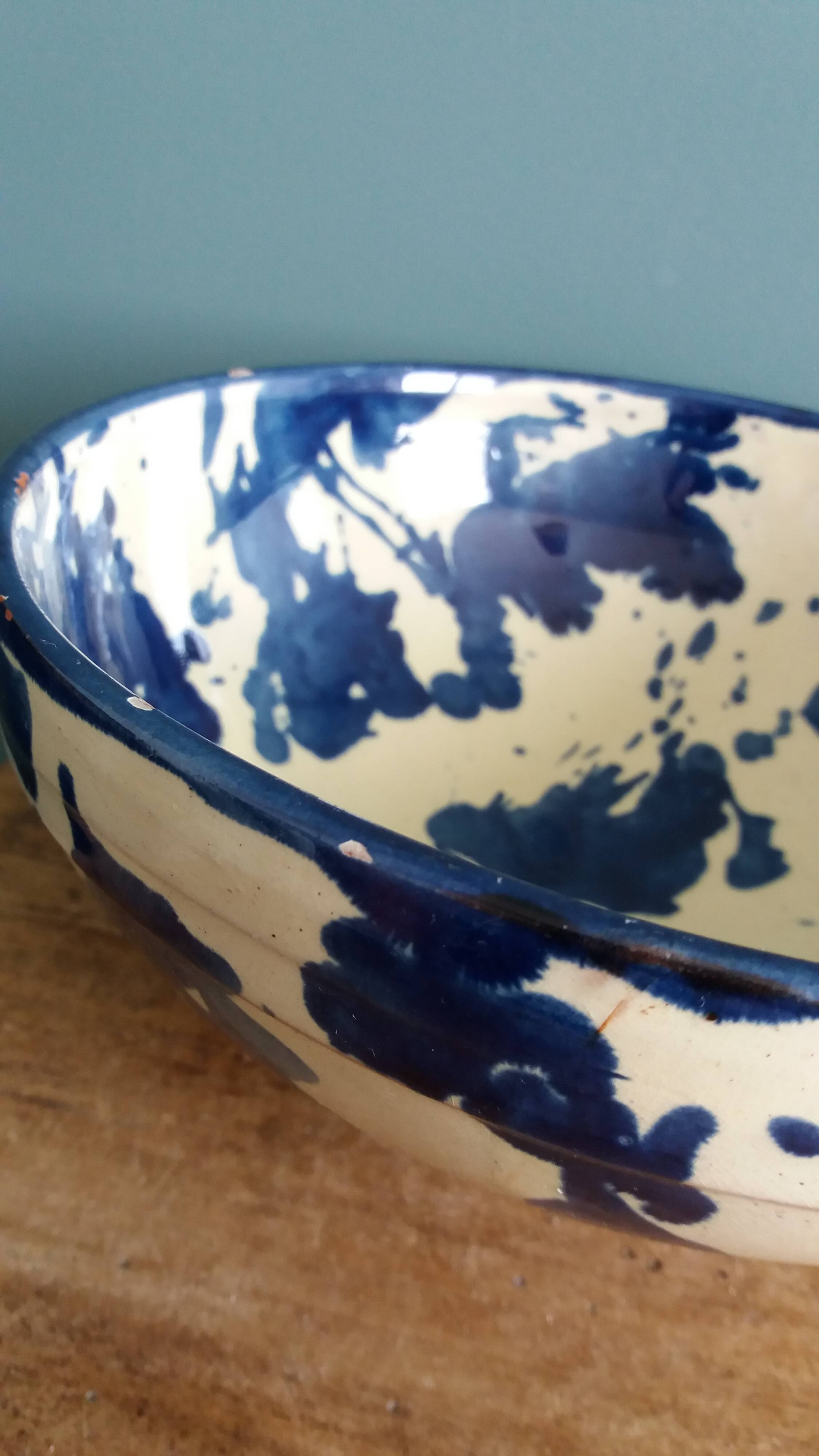 Empty pocket bowl in terracotta, glazed with "ink spots" design.