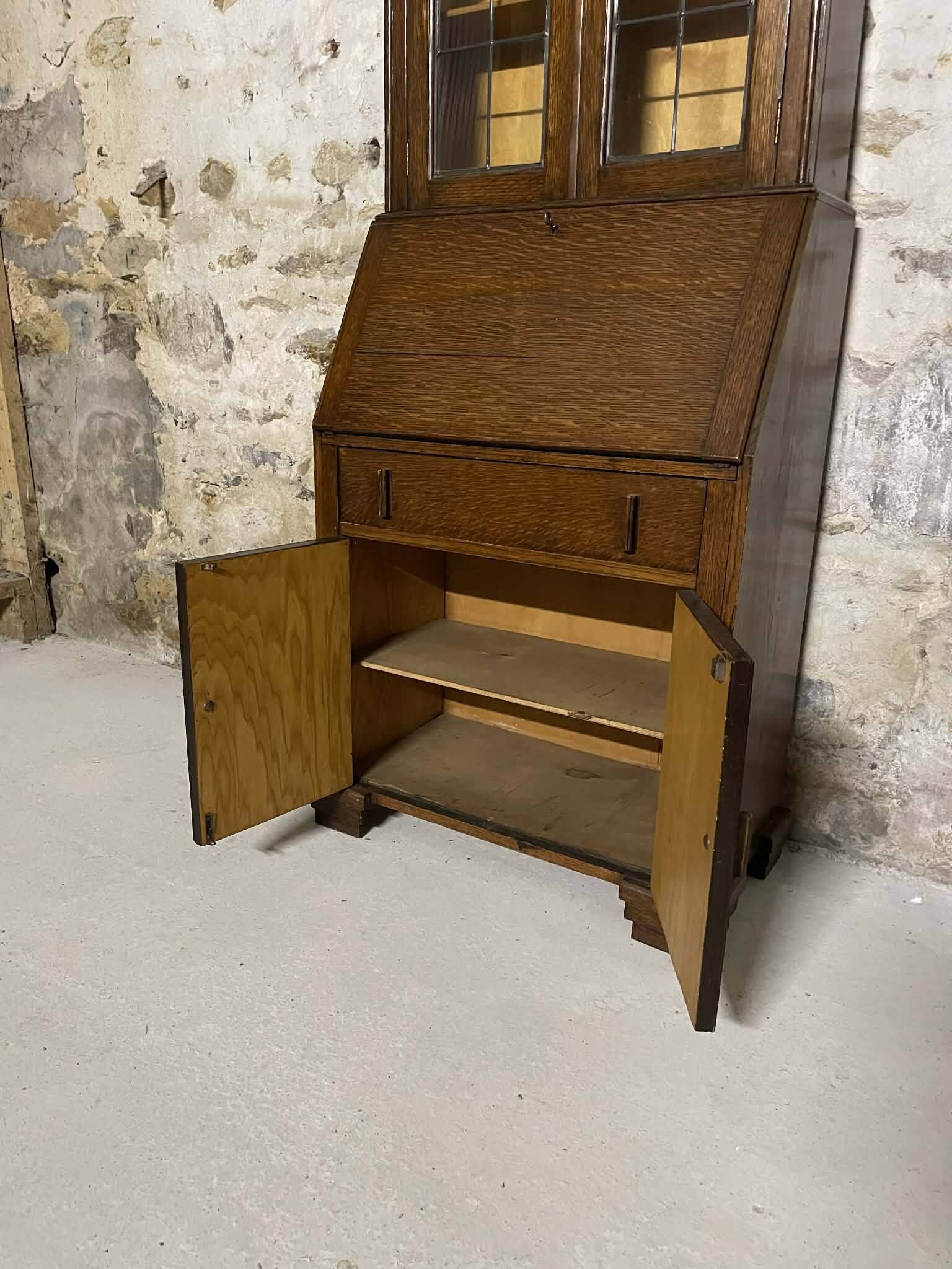 Oak display secretary cabinet with drop-down front, two sections.
