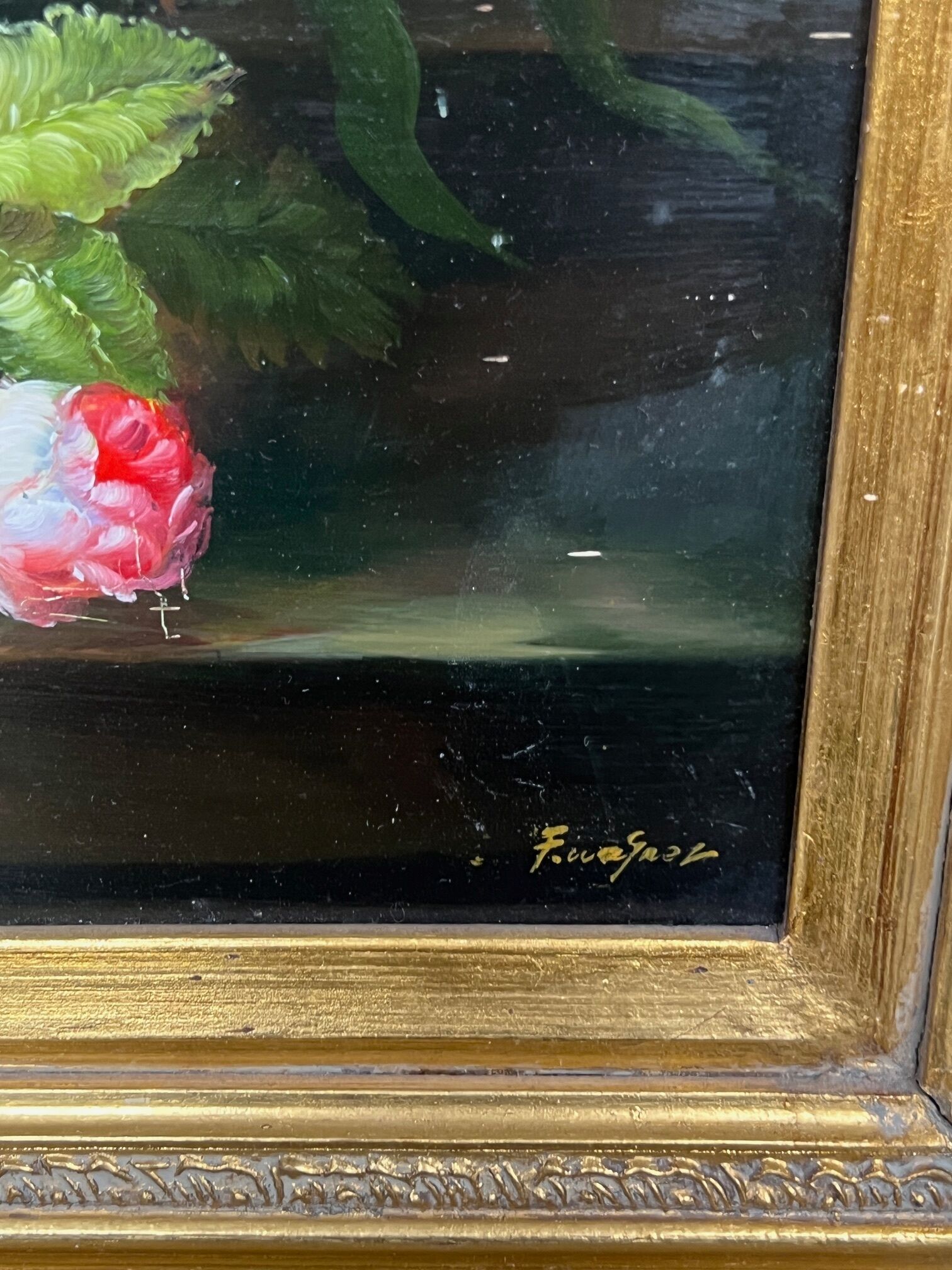 Still life with roses in a beautiful frame on a wooden panel in Flemish style.