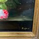 Still life with roses in a beautiful frame on a wooden panel in Flemish style.