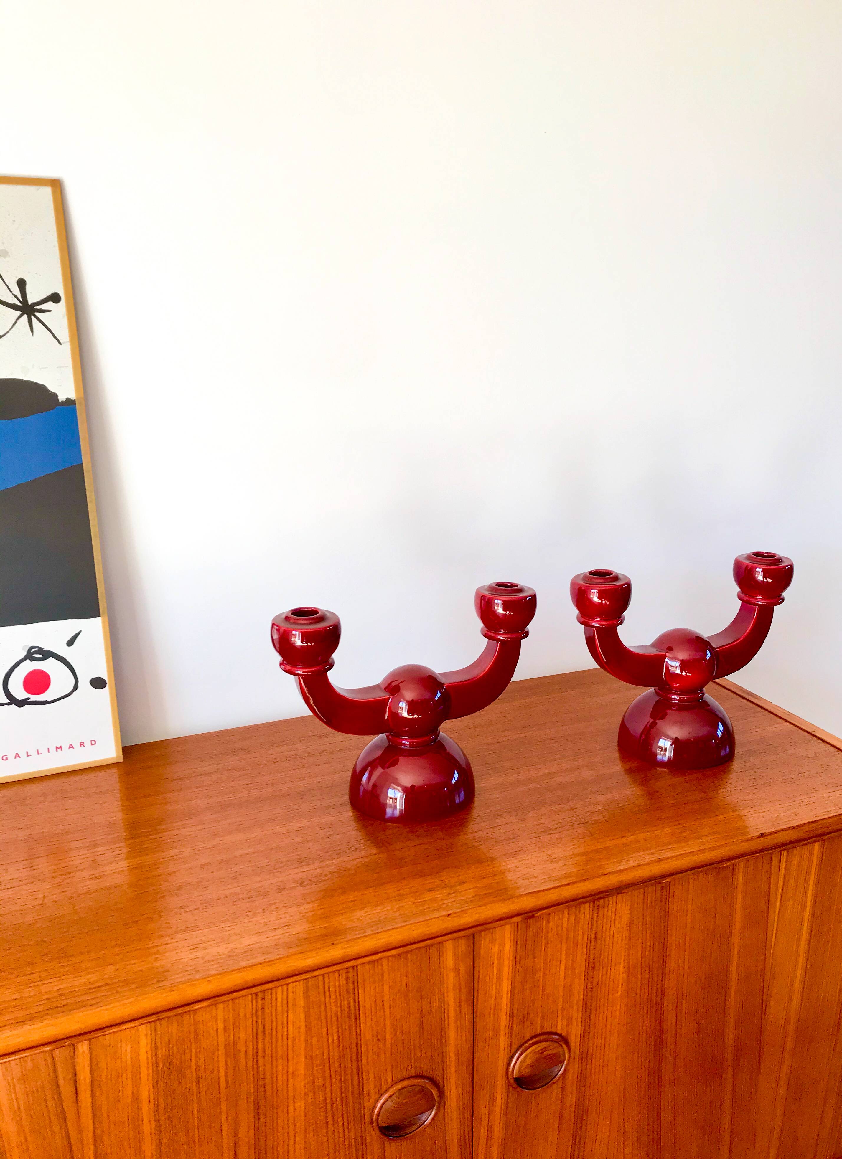 pair of burgundy enameled ceramic candlesticks / candelabras signed 1949
