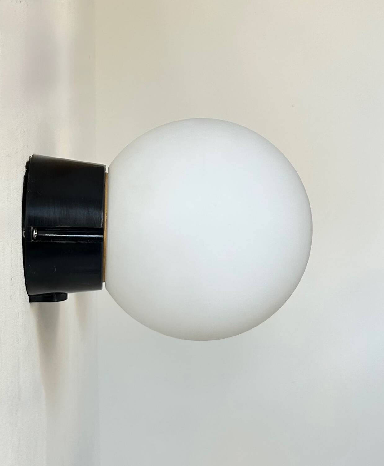 Pair of vintage Raak opaline and Bakelite wall lights, Netherlands 1970s