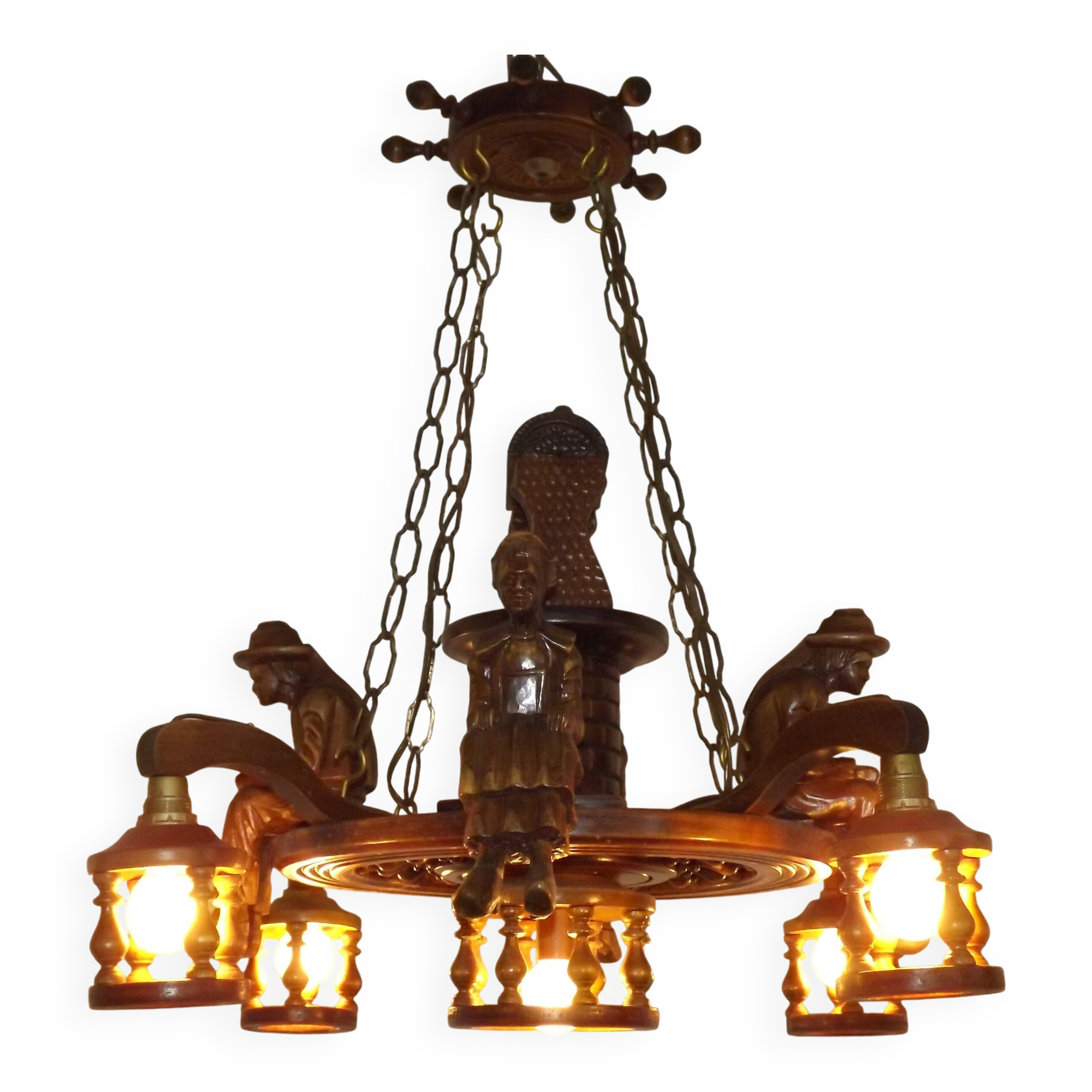 French vintage Breton chandelier with hand-carved figures, well, and lantern lights.