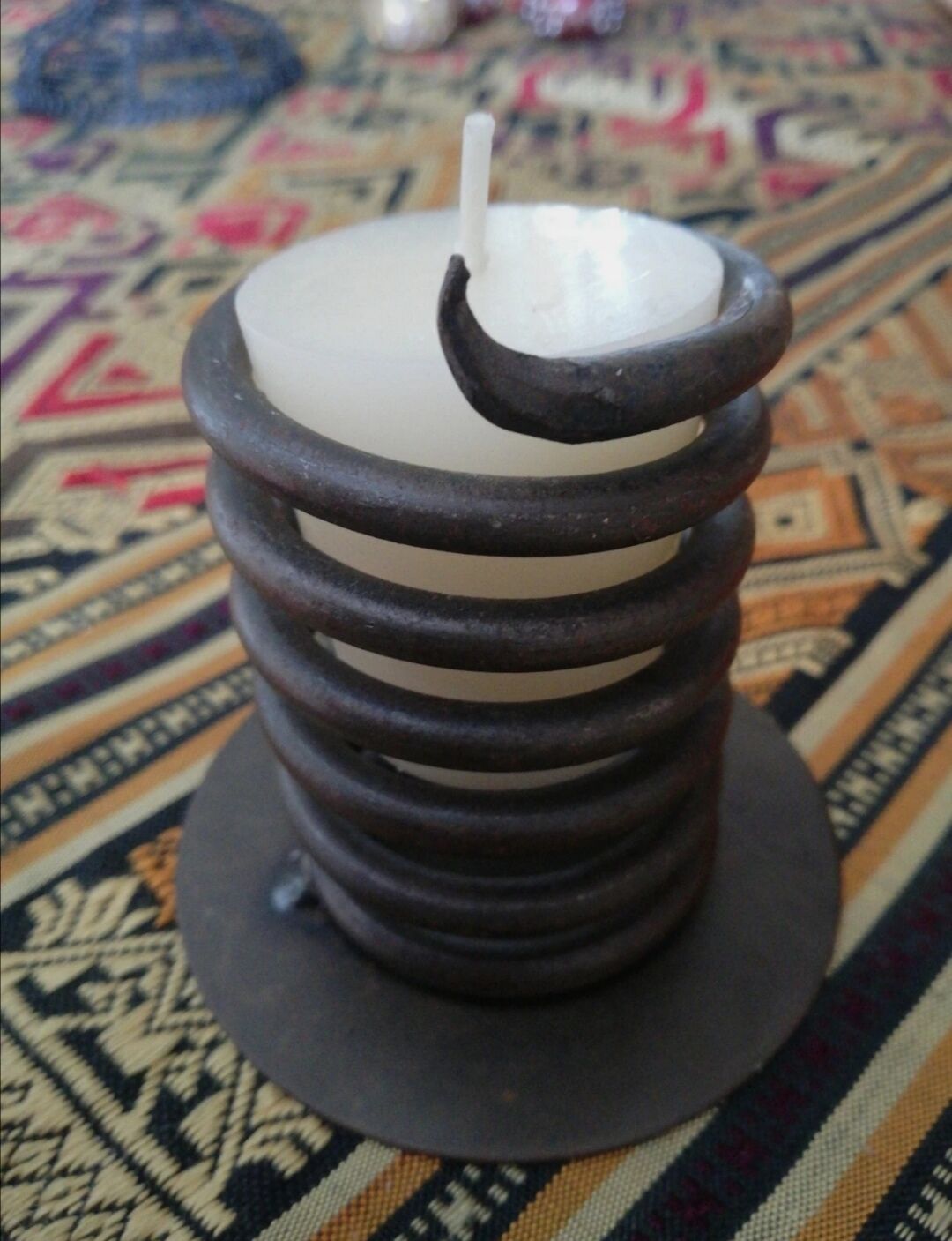 Spiral metal candle holder spring with candle, bronze appearance