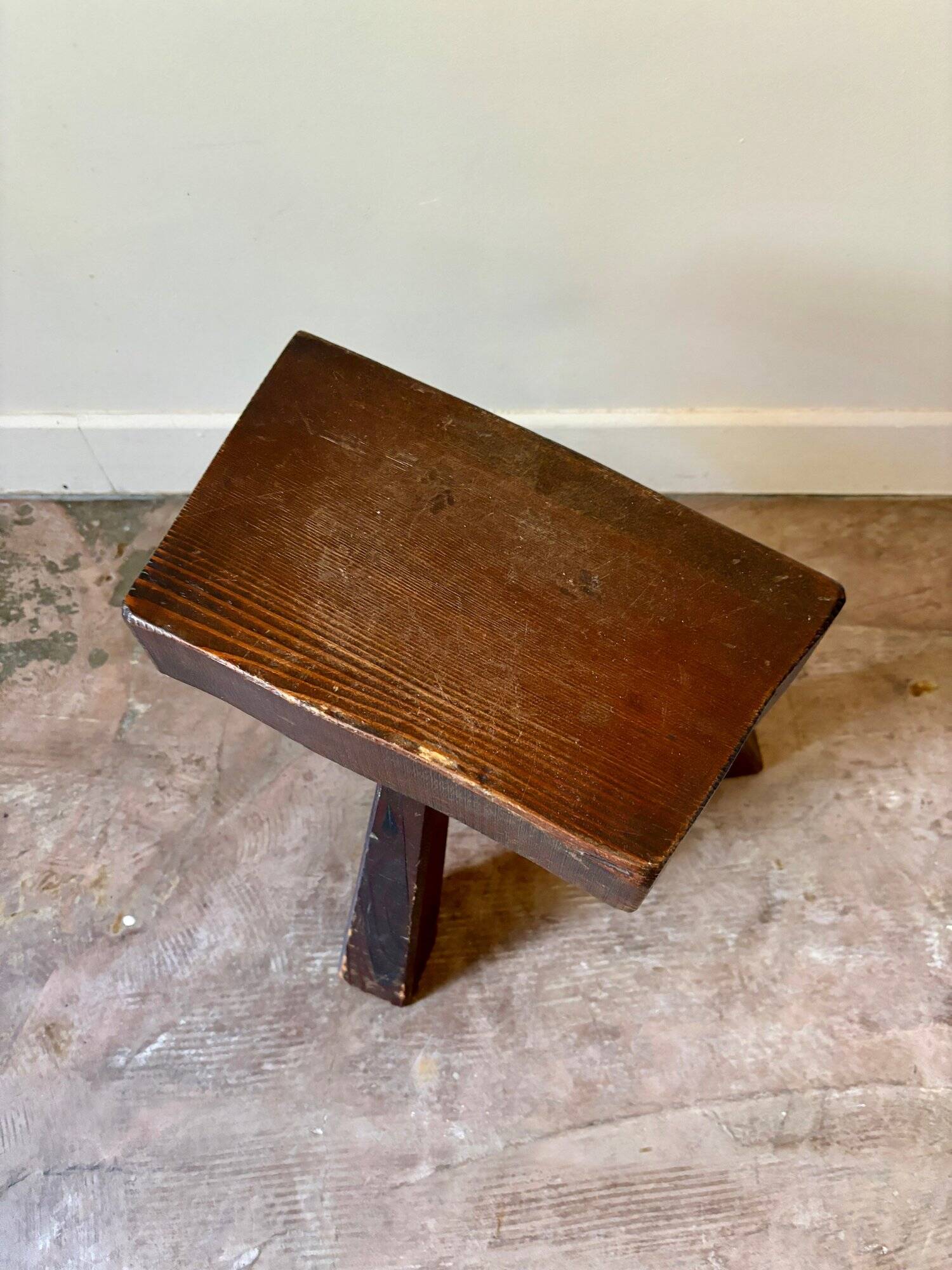 Brutalist tripod stool in dark wood