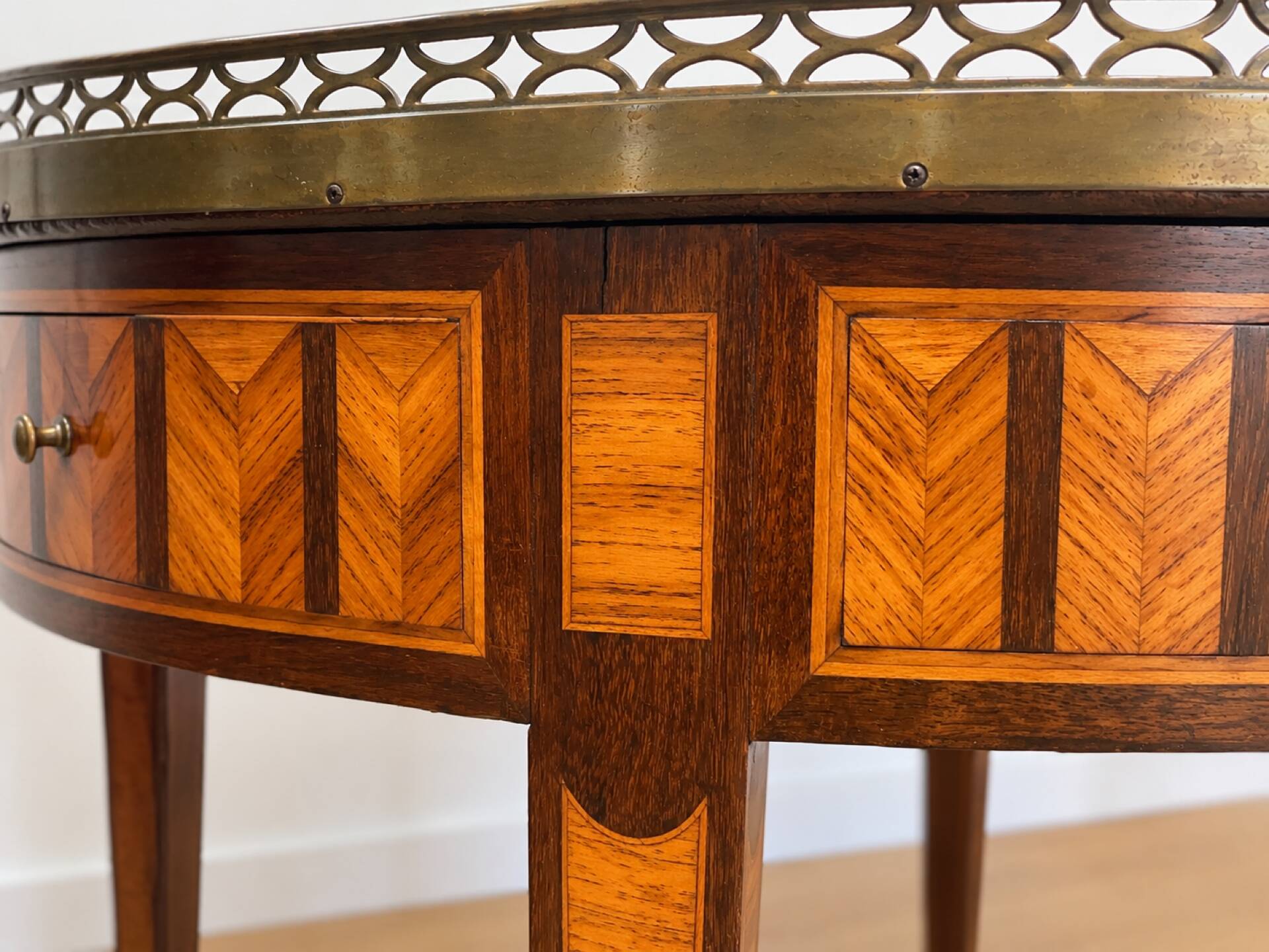 Bouillotte table in Louis XVI style with marquetry, marble, and brass.