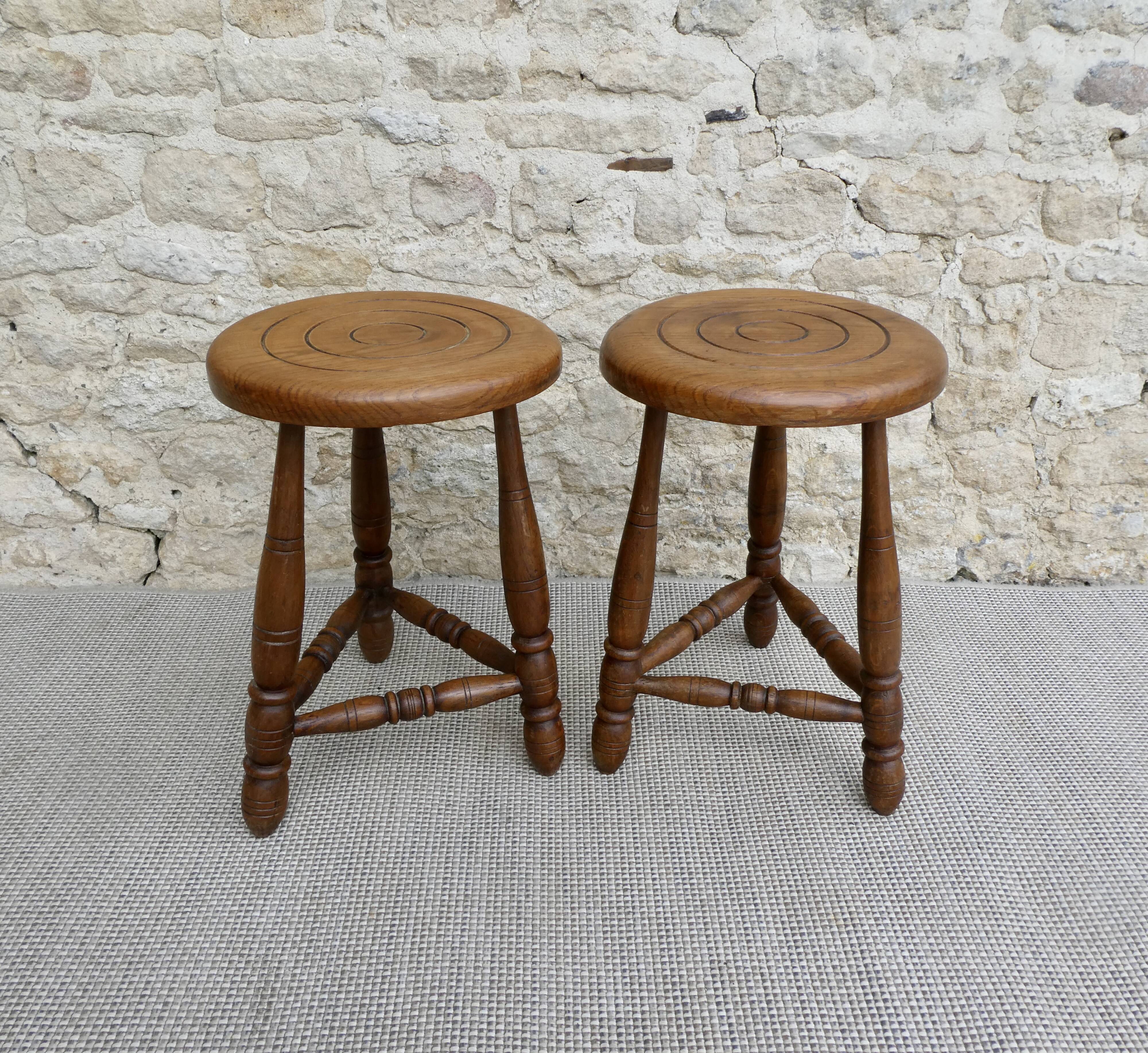 Pair of solid wood tripod stools, carved.
