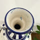 white amphora-style vase with hand-painted blue patterns